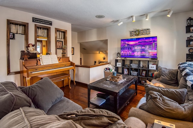 living room with a textured ceiling and wood finished floors