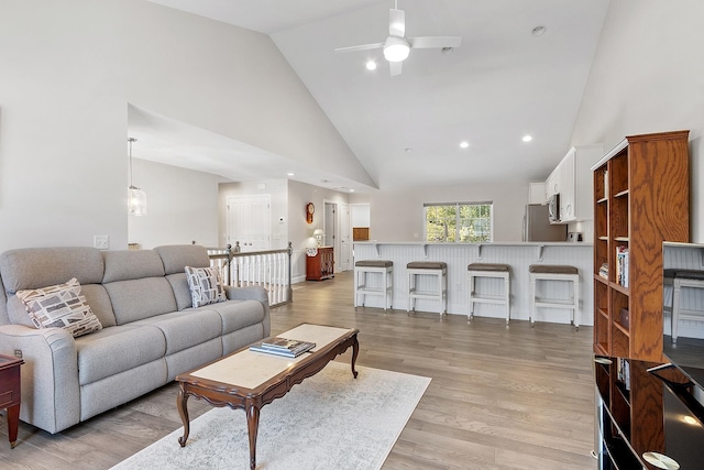 living area featuring high vaulted ceiling, recessed lighting, light wood-style flooring, and a ceiling fan