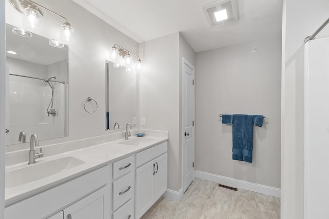 full bathroom with marble finish floor, visible vents, and a sink