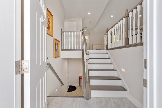 stairs featuring baseboards and recessed lighting