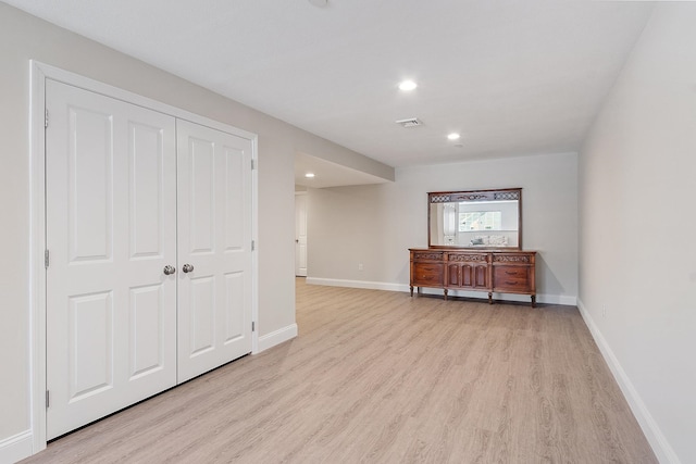 interior space featuring light wood finished floors, visible vents, baseboards, and recessed lighting