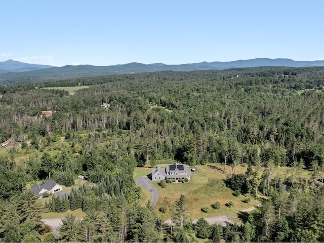 birds eye view of property with a mountain view and a forest view