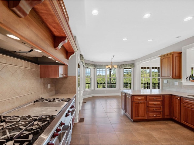 kitchen with brown cabinets, light countertops, double oven range, and premium range hood