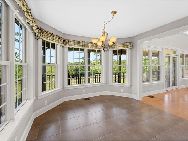 unfurnished sunroom with a chandelier and visible vents