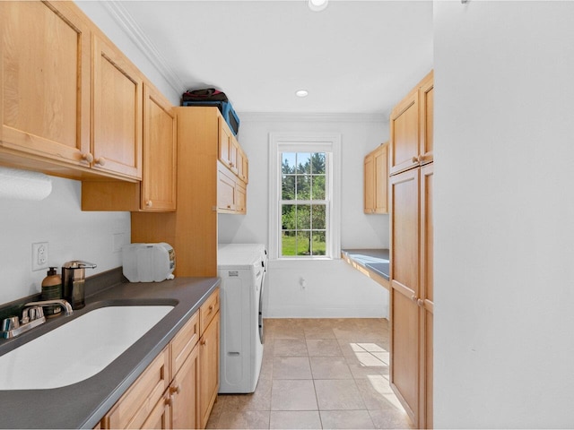 laundry room with light tile patterned floors, a sink, independent washer and dryer, cabinet space, and crown molding