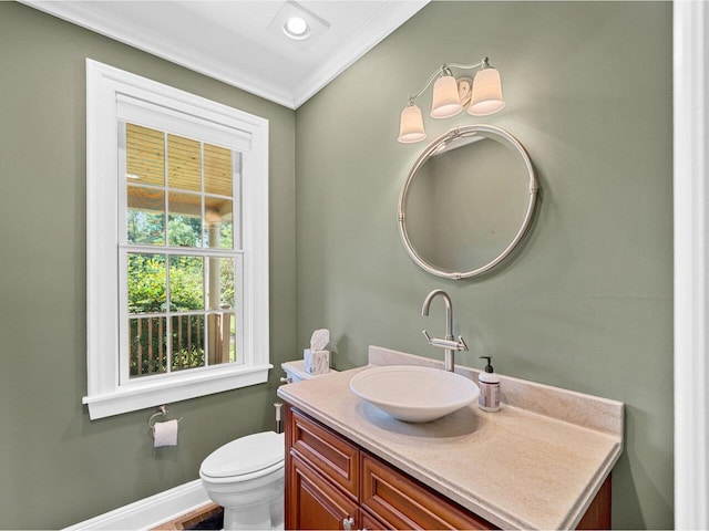 half bath featuring crown molding, recessed lighting, toilet, vanity, and baseboards