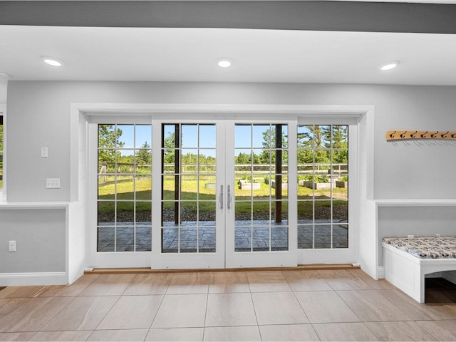 doorway with light tile patterned flooring, a wealth of natural light, and recessed lighting