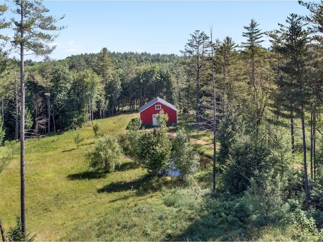 birds eye view of property featuring a view of trees