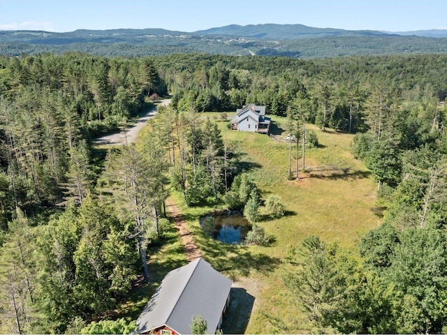 birds eye view of property with a forest view and a mountain view