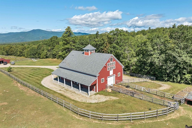 bird's eye view with a mountain view, a view of trees, and a rural view