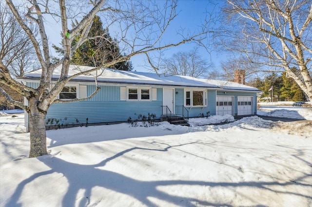 single story home with an attached garage and a chimney