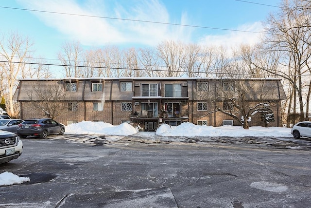 view of front of property with uncovered parking and brick siding