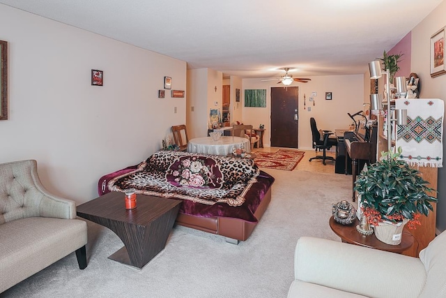 living room with ceiling fan and carpet