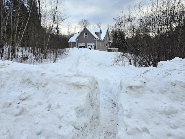 yard covered in snow with a garage