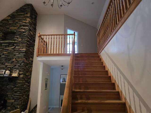 96 Mason Dr, Milan, NH 03588 - stairway featuring high vaulted ceiling, a notable chandelier, and baseboards