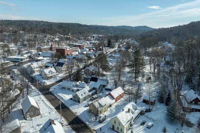 snowy aerial view with a mountain view