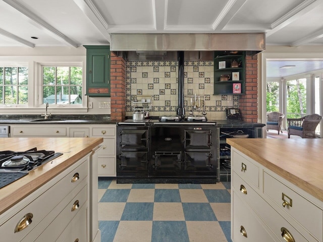 kitchen featuring light floors, butcher block countertops, and plenty of natural light