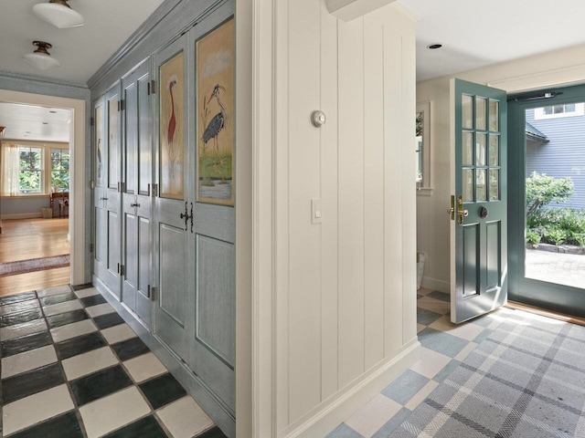 interior space featuring light floors and ornamental molding