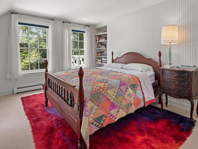 bedroom featuring carpet floors and a baseboard heating unit