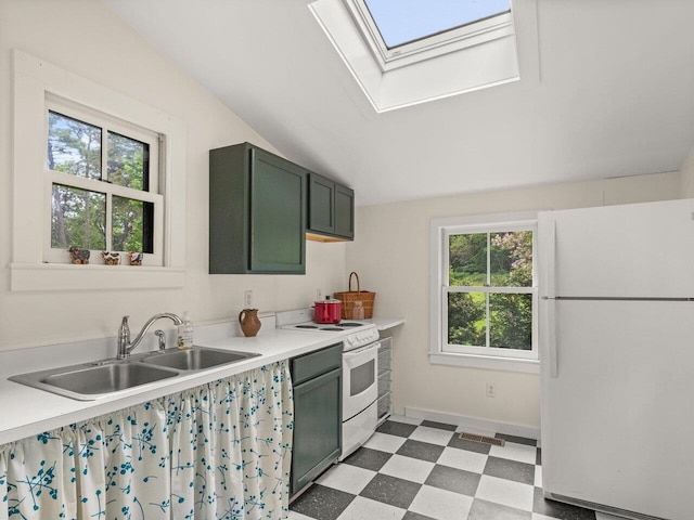 kitchen featuring white appliances, green cabinetry, a sink, and tile patterned floors