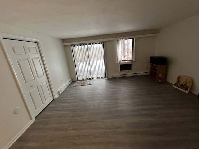 unfurnished living room with a baseboard heating unit and dark wood-style floors