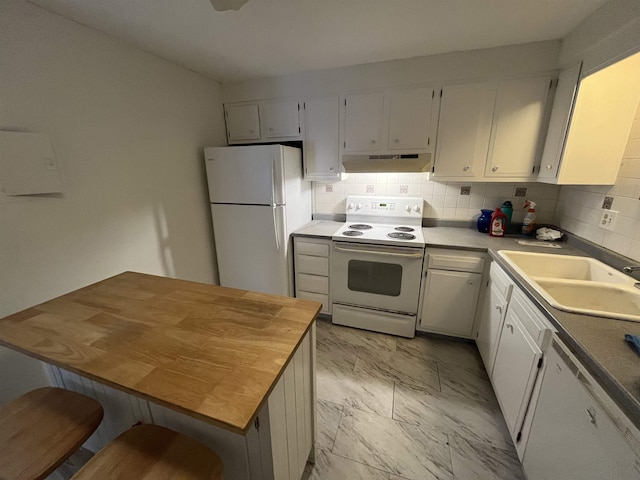 kitchen with under cabinet range hood, white appliances, a sink, marble finish floor, and backsplash