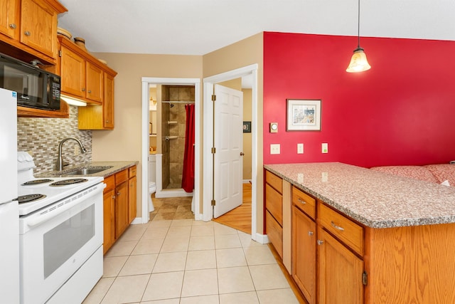 kitchen with white range with electric cooktop, decorative backsplash, brown cabinetry, black microwave, and a sink