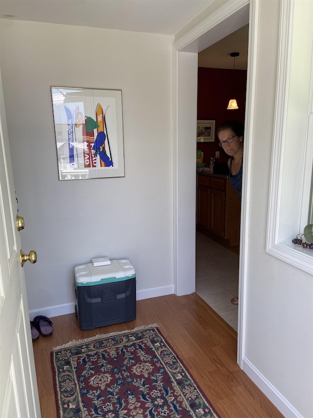 interior space featuring baseboards and wood finished floors