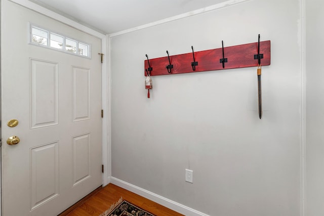 doorway featuring wood finished floors and baseboards