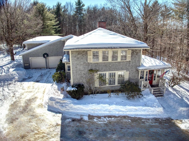 view of front of house with a chimney and an attached garage