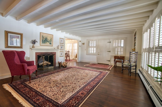 living area featuring dark wood finished floors, a fireplace, baseboard heating, beamed ceiling, and baseboards