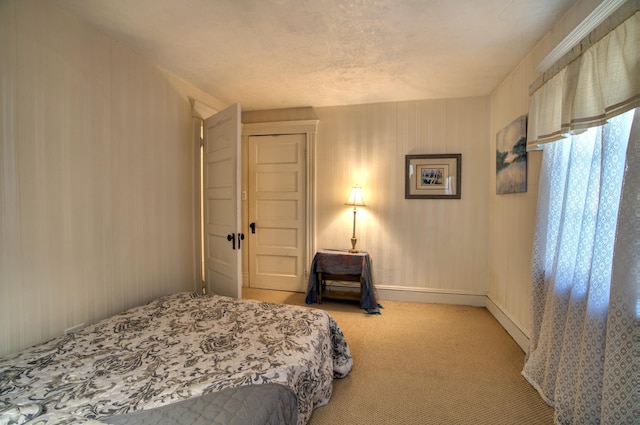 bedroom with carpet floors and baseboards