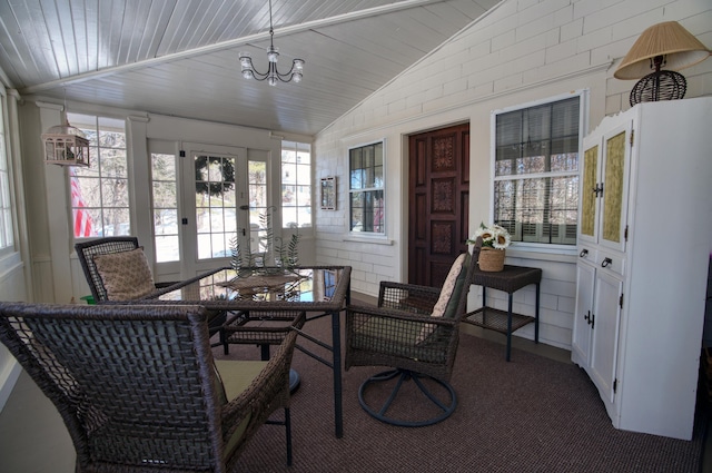 sunroom with lofted ceiling, an inviting chandelier, and wooden ceiling