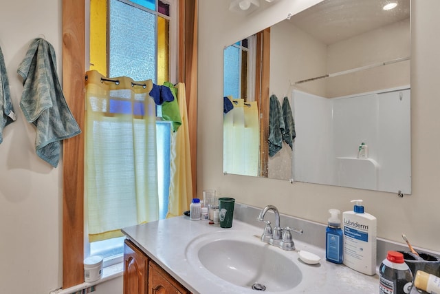 full bath featuring vanity and walk in shower