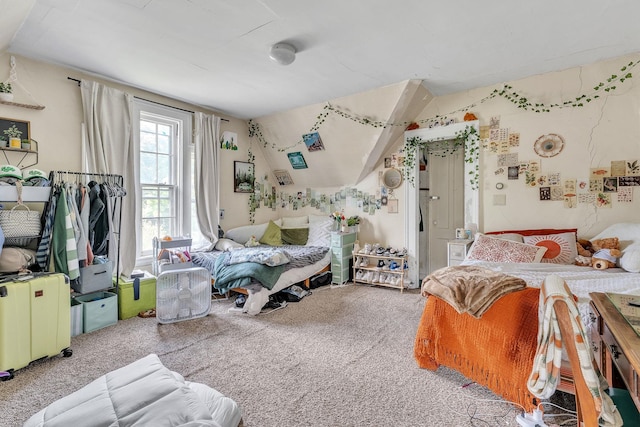 carpeted bedroom featuring lofted ceiling