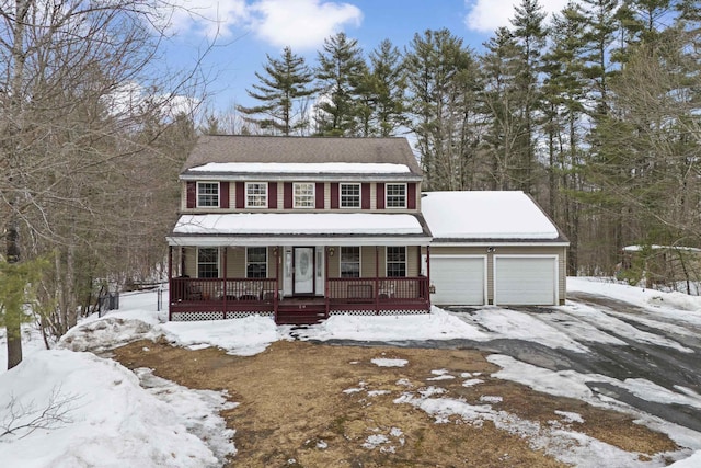 view of front of property featuring driveway, a porch, and an attached garage