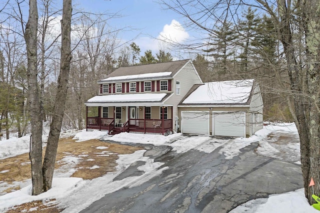 view of front of home with covered porch, aphalt driveway, and a garage