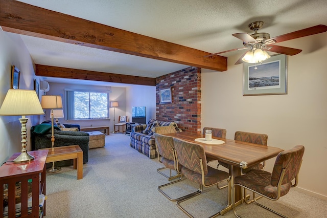 carpeted dining area featuring a textured ceiling, ceiling fan, beamed ceiling, and baseboards