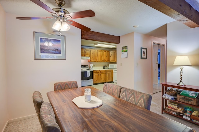 dining space with baseboards, light colored carpet, ceiling fan, a textured ceiling, and beam ceiling