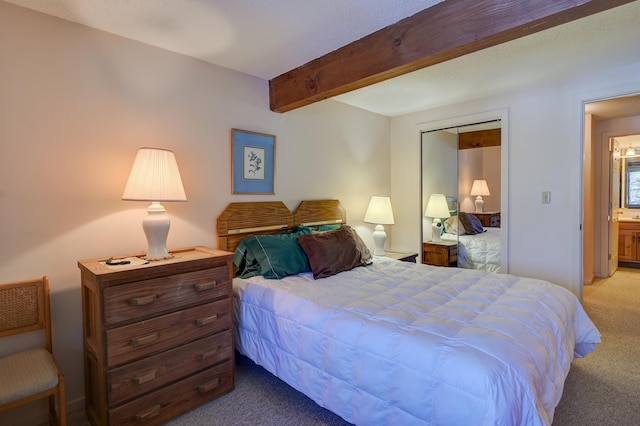 bedroom with beamed ceiling and carpet flooring