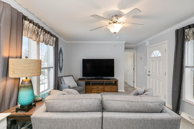 living room with a ceiling fan, baseboards, visible vents, and crown molding