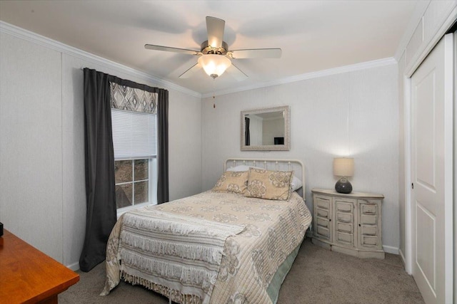 carpeted bedroom featuring a closet, a ceiling fan, and crown molding