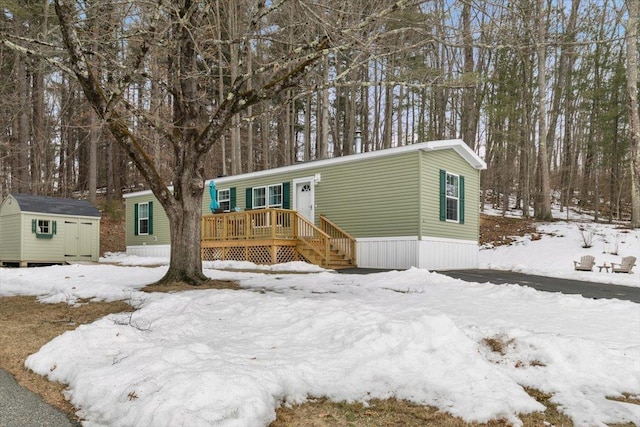 view of front of property with an outdoor structure and a shed