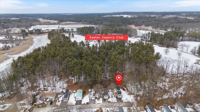 snowy aerial view featuring a forest view