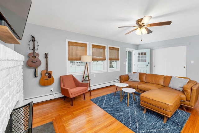 living room featuring ceiling fan, baseboard heating, a baseboard radiator, and wood finished floors