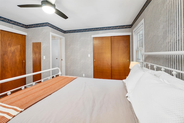 bedroom with a closet, a ceiling fan, and wallpapered walls