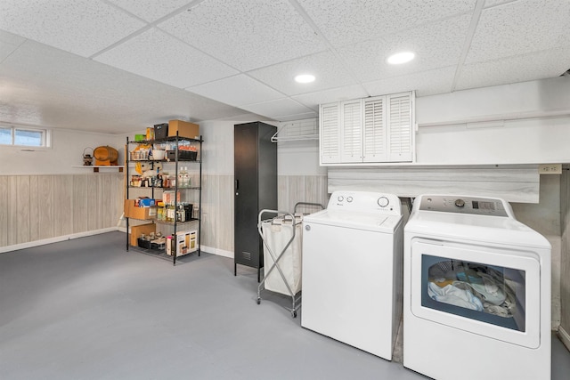 washroom with washing machine and dryer, a wainscoted wall, wooden walls, and recessed lighting