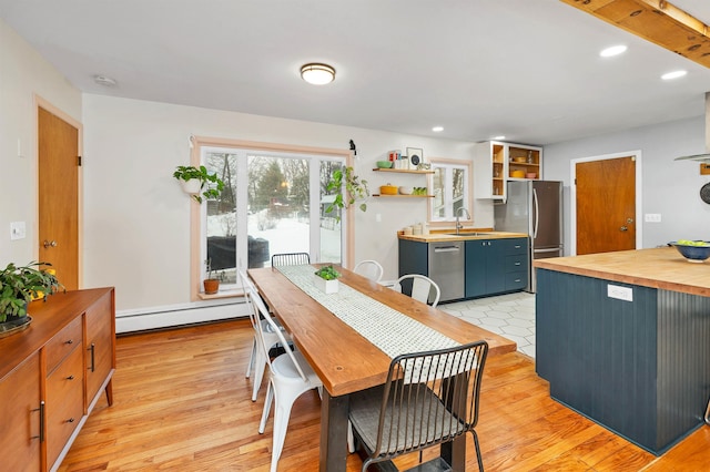 dining area with a baseboard heating unit, recessed lighting, and light wood-style floors