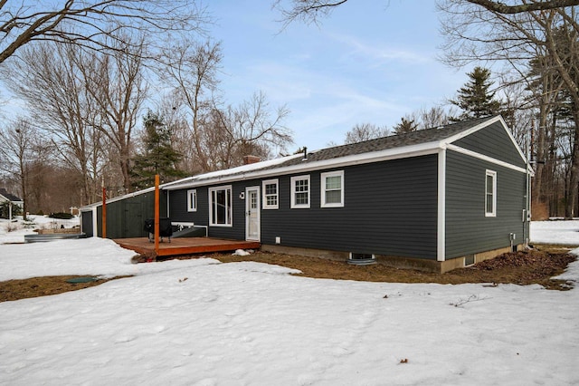 view of front of property with a chimney and a wooden deck