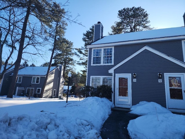 view of front of home with a garage and a chimney